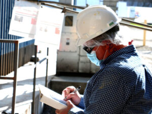 SSI certified engineer conducting an on-site Dust Hazard Analysis (DHA) assessment in an industrial facility