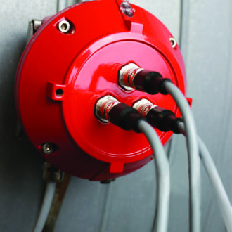 Close-up view of the FLAMEX YMX 5000 IR Spark Detector with its wiring connections